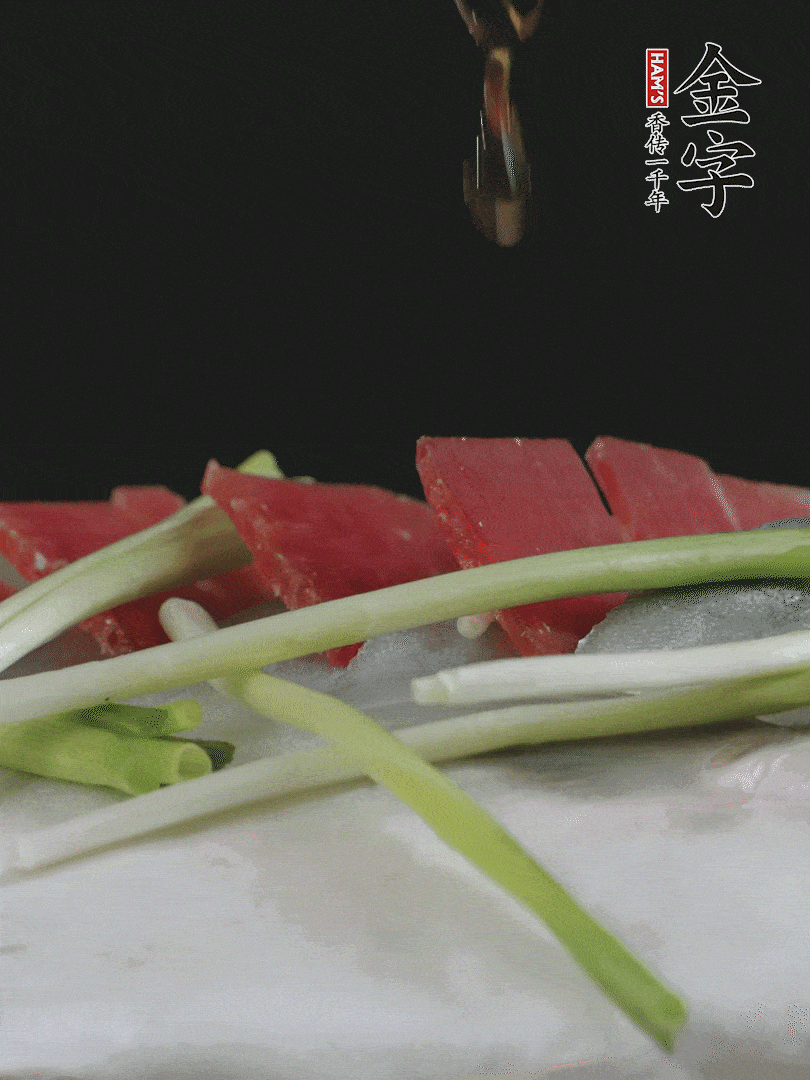 蔥白置于魚(yú)身，放適量豌豆，淋上花雕酒。